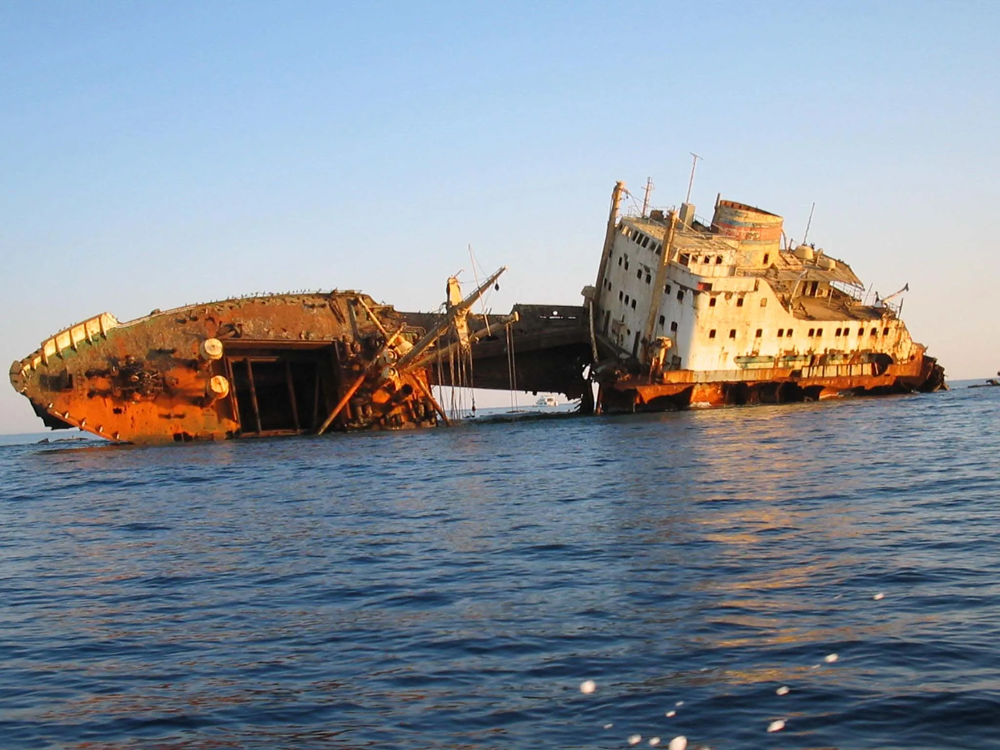 Dramatic rusted shipwreck in deep blue Red Sea water near Tiran Island.