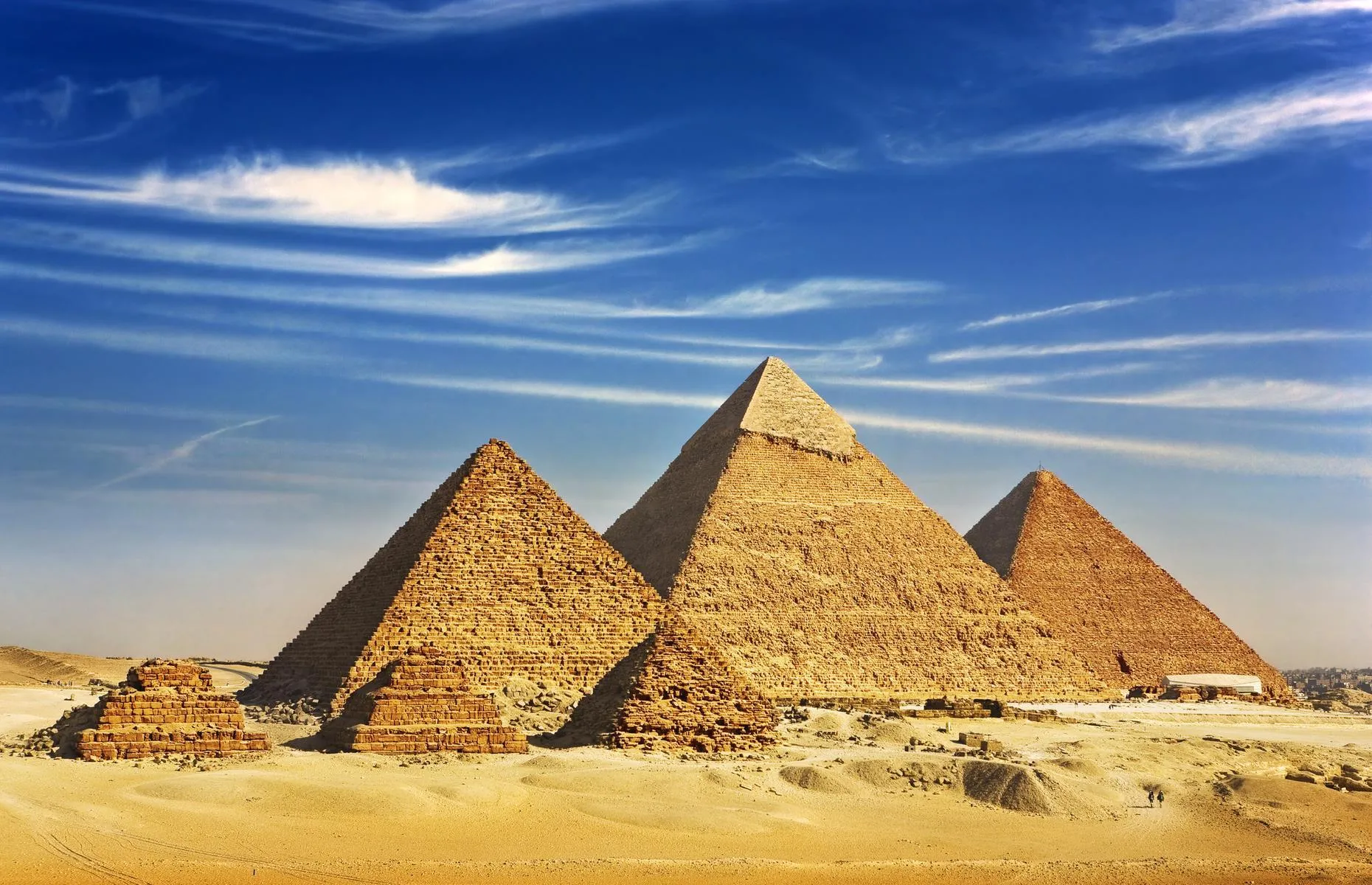 Majestic Pyramids of Giza at sunset, ancient wonders in the vast Egyptian desert.